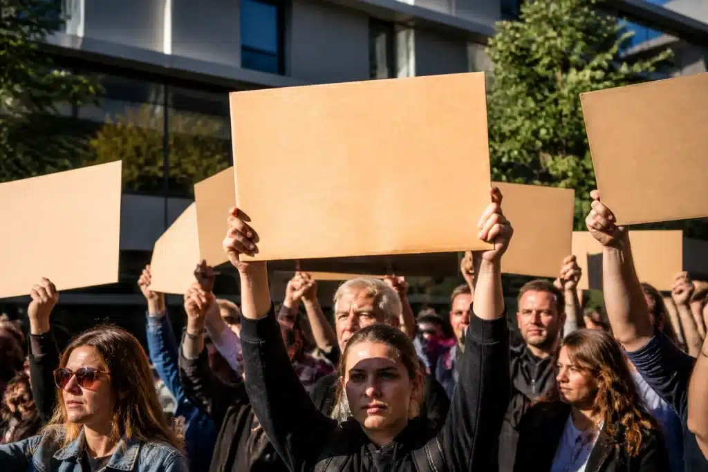 Residents gathering with signs demanding transparency documents