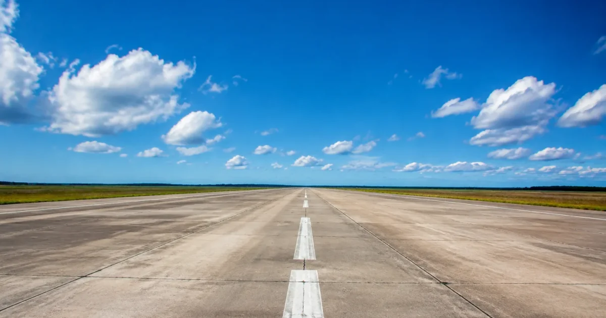 Longue piste de beton deserte etendant vers horizon